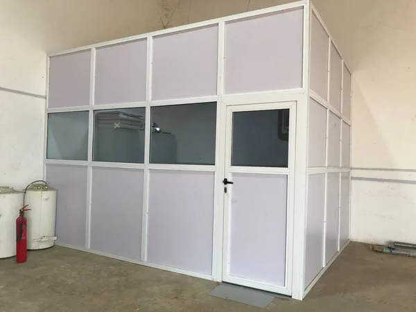 Semi glazed door and panels made of aluminum for an warehouse office installed on a concrete floor