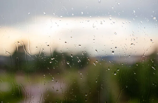 Rainy day through the window on sky and city buildings background — Stock Photo, Image