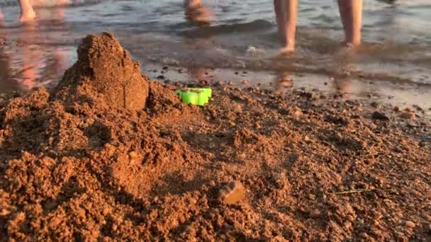 Small Child Plays Beach Pond Sunset Builds Houses Out Sand — Stock Video