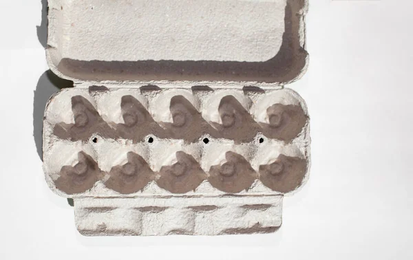 Grey egg carton without eggs on white background. — 图库照片