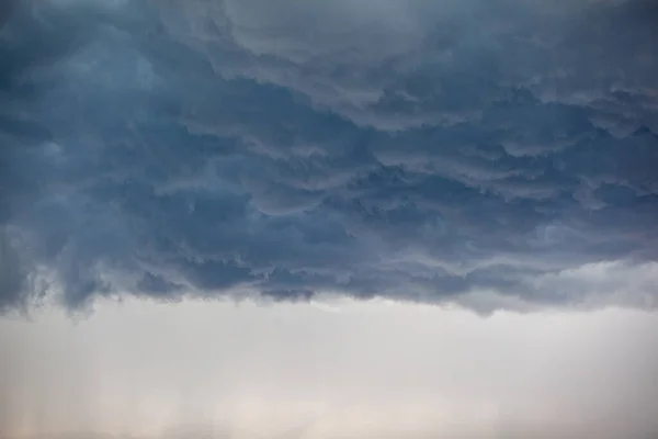 Dramatic sky with grey clouds over the city before the storm. Weather before or after a storm.