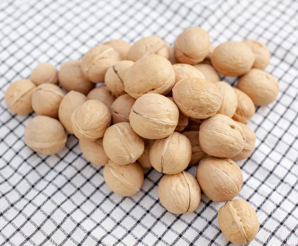 A lot of whole walnuts on a napkin. Healthy, organic and healthy food