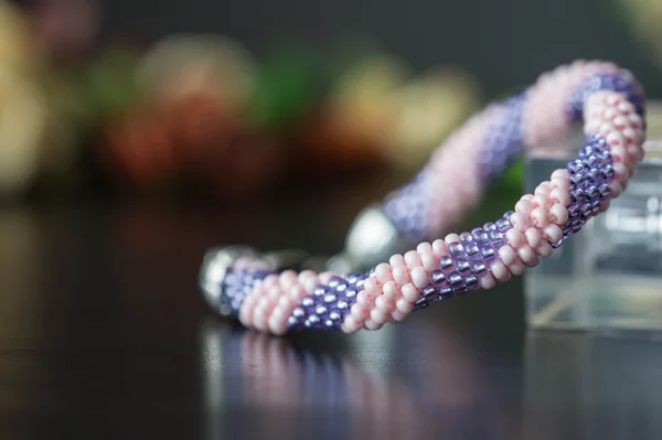 Handmade crochet beaded bracelet from beads of pink and lilac color