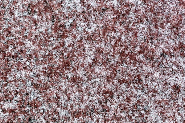 Abstract frozen ice background. Frozen raindrops, freezing rain close up. Winter abstract white-brown background. Frozen drops of rain on a tile.