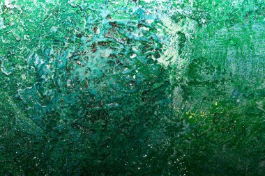 Dekoratif alçı. Soyut desenli yeşil arka plan. İç duvarda el yapımı alçı var..