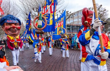 16 Şubat 2026. Mainz Rosenmontag Geçidi, Mainz, Almanya. MCV logosu olan Schwellkopp heykelciği ve neşeli katılımcı kalabalığı..