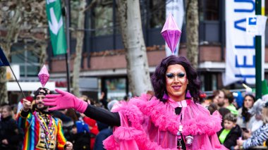 February 16, 2026. Rosenmontag Parade, Mainz, Germany. A vibrant drag performer in a bright pink costume radiates Mainz's carnival energy.