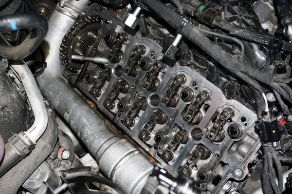 The cylinder head of a modern powerful engine. Engine repair in a car service. Selected focus.