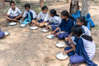 Students at a government school in West Bengal, India, waiting for the Mid Day Meal. Mid-Day-Meal is a lunch provided free by the Indian Government.