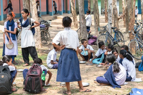 Students at a government school in West Bengal, India, waiting for the Mid Day Meal. Mid-Day-Meal is a lunch provided free by the Indian Government.