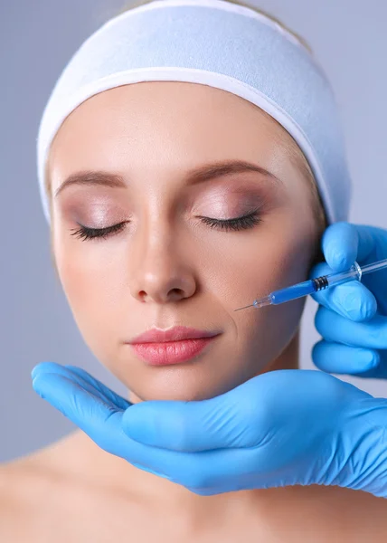 Cosmetic injection on the pretty woman face. Isolated on gray background — Stock Photo, Image