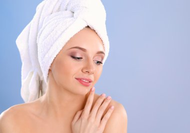 Başında bir gri arka plan üzerine bir havlu ile güzel kadın