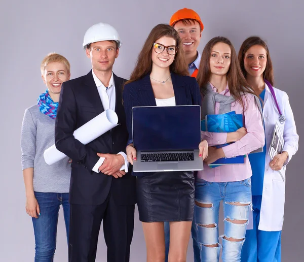 Smiling businesswoman with laptop  and group of industrial workers — Stock Photo, Image
