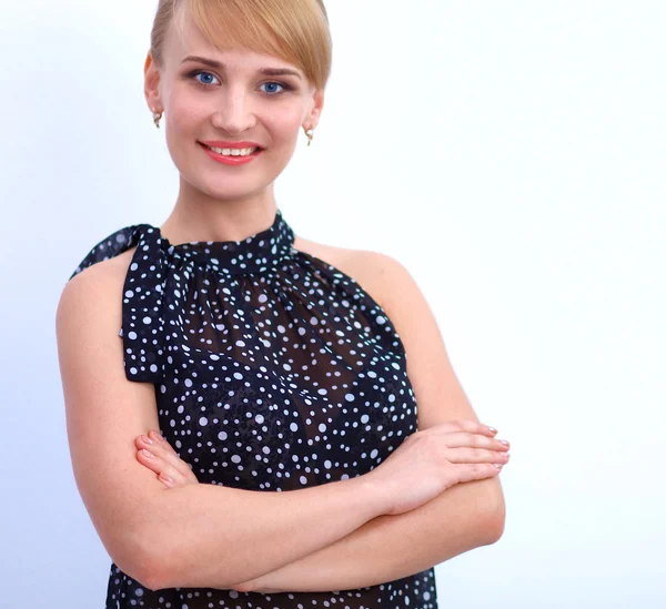 Portrait of an attractive young woman standing with crossed arms — Stock Photo, Image