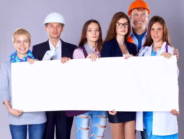 Portret van lachende mensen met verschillende beroepen die blanco reclamebord houden — Stockfoto