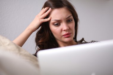 Koltukta oturan dizüstü kullanan mutlu güzel kadın