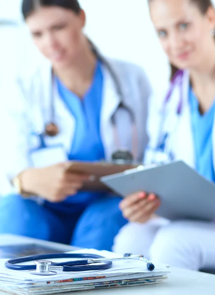 Two young women doctors sitting on the sofa — Stock Photo, Image