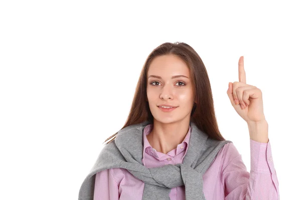 Mujer joven señalando hacia arriba con el dedo índice, aislada sobre fondo blanco —  Fotos de Stock
