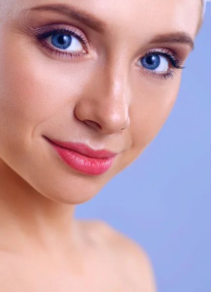 Beautiful woman with a towel on his head on a gray background — Stock Photo, Image