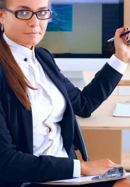 Young woman working in office, sitting at desk — Stock Photo, Image