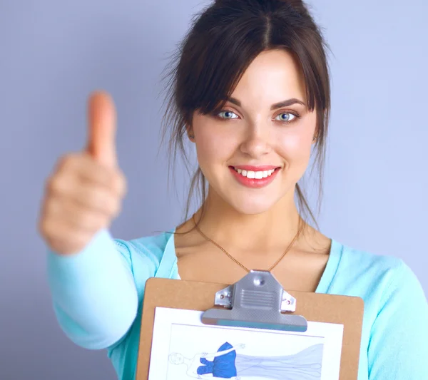 Young brunette showing big thumbs up on white background — Stock Photo, Image