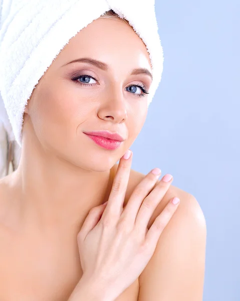 Beautiful woman with a towel on her head on a gray background Royalty Free Stock Images