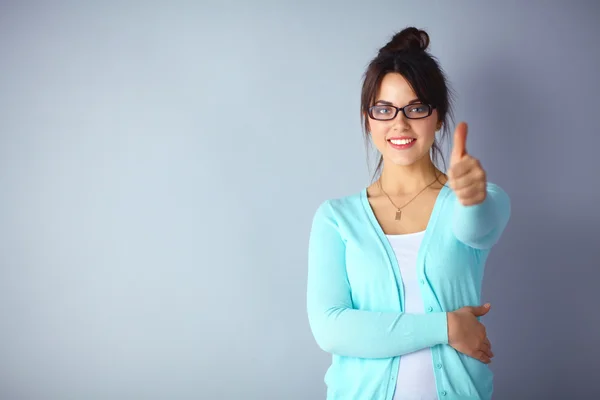 Young brunette showing big thumbs up on white background — Stock Photo, Image