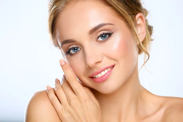 Young woman touching her face isolated on white background — Stock Photo, Image