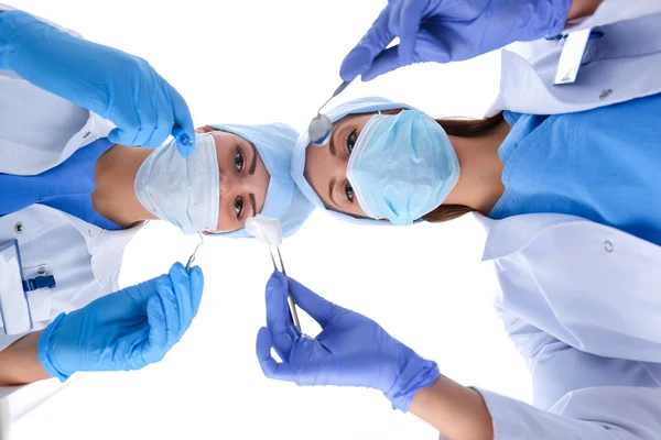 Surgeons team, man and woman wearing protective uniforms,caps and masks — Stock Photo, Image