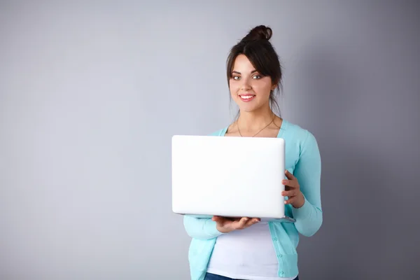 Happy young woman using her laptop — Stock Photo, Image