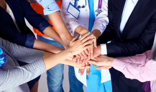 Portrait of people with various occupations putting their hands on top of each other — Stock Photo, Image