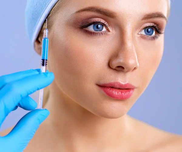 Kosmetiska injektion i vacker kvinna ansiktet. Isolerad på grå bakgrund — Stockfoto