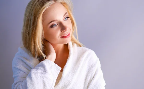 Smiling woman in white bathrobe — Stock Photo, Image