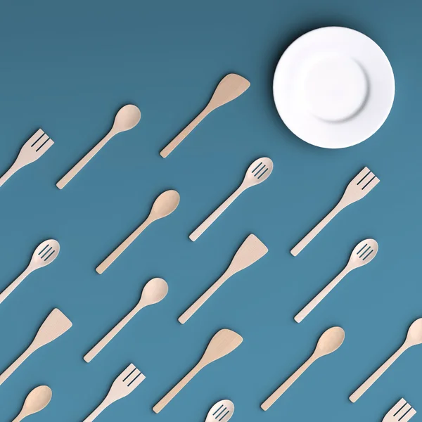 Біла тарілка з дерев'яними кухонними інструментами — стокове фото