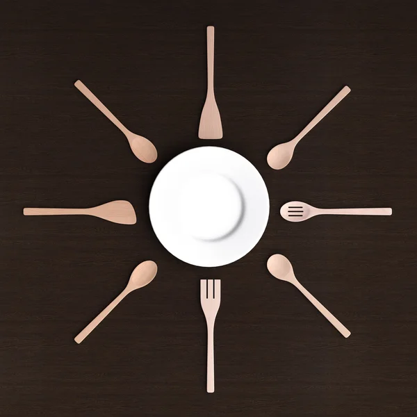 Белая тарелка с деревянными кухонными инструментами — стоковое фото