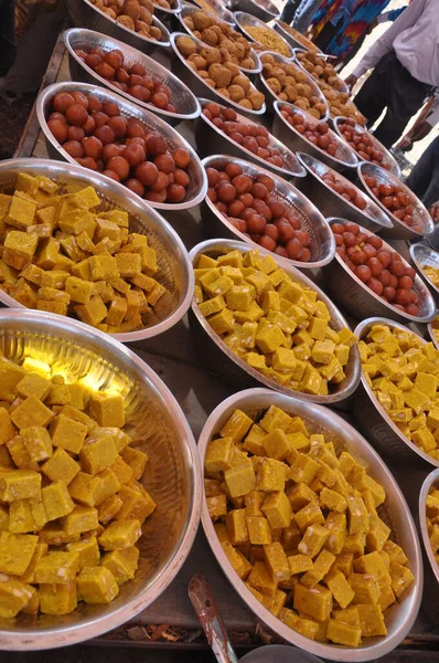 sweets for indian hindu marriage, gulab jamun, cashew katli and snacks placed in steel plate
