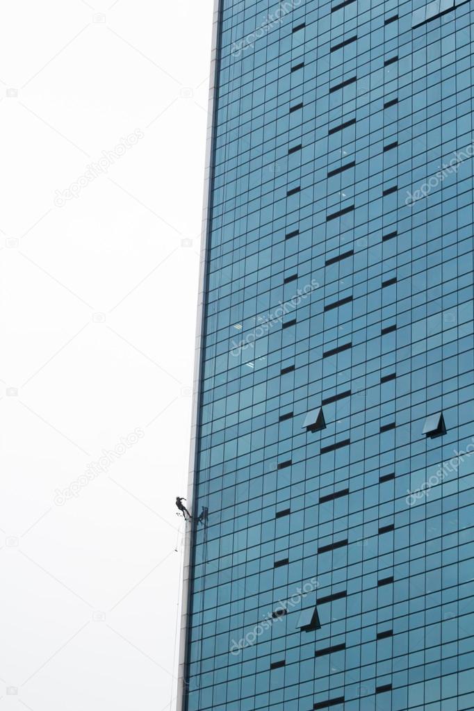 Man climbing on wall of building