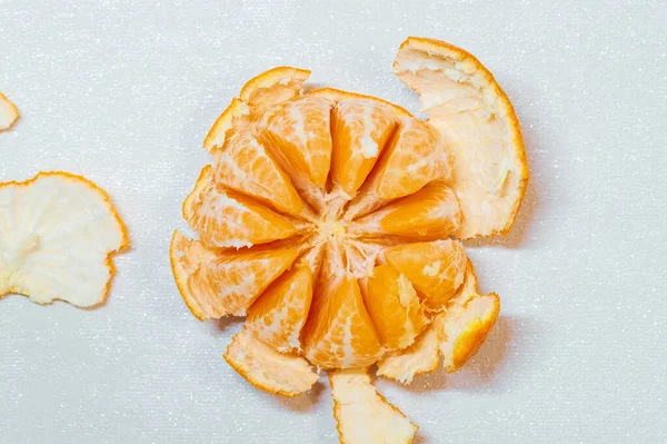 Ripe juicy peeled orange mandarine, tangerine, clementine isolated on white background, top view. orange peel, orange rind. Food Background