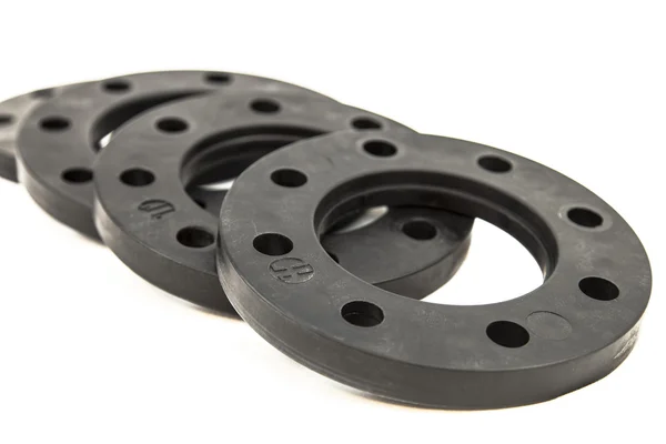 Black plastic flanges on a white background — Stock Photo, Image