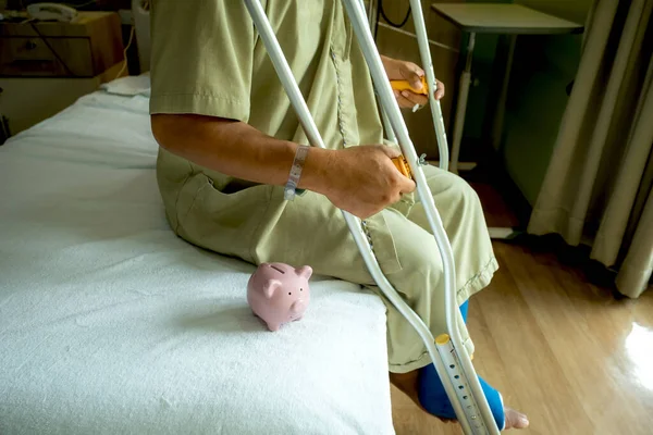 Piggy Bank Man Leg Uses Crutches Walk Surgery Recovery Injury — Stock Photo, Image