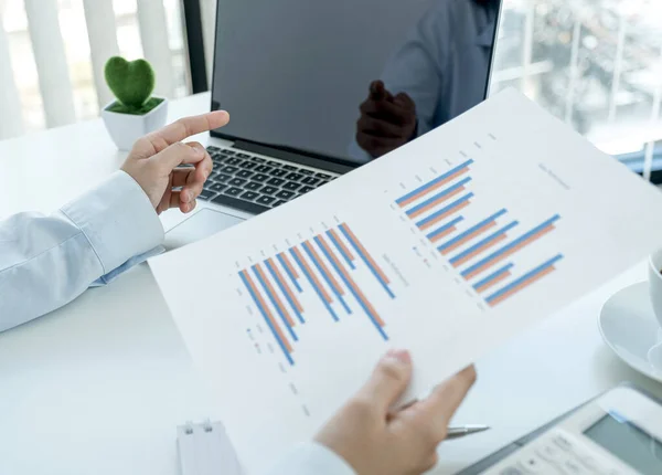 Businesswoman hand pointing to the monitor and analysis the chart and meeting Video Conferencing with laptop at the home office for setting challenging business goals and planning new target.