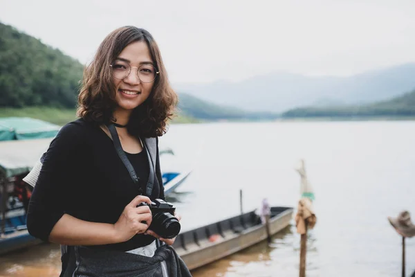若いアジアの観光客は 自然の湖を見学する自由時間を過ごす 趣味で写真を撮るのが好き — ストック写真