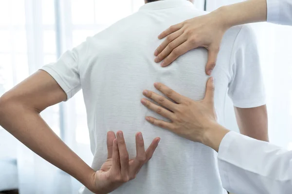 Female Doctor Hands Doing Physical Therapy Extending Back Male Patient — Stock Photo, Image