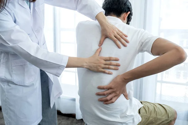 Female Doctor Hands Doing Physical Therapy Extending Back Male Patient Royalty Free Stock Images