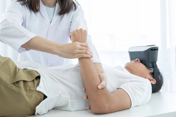 Female Doctor Hands Doing Physical Therapy Extending Arm Male Patient — Stock Photo, Image