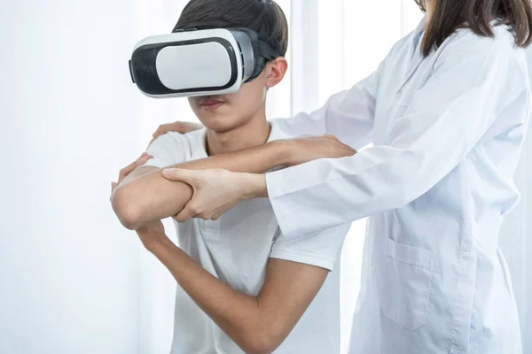 VR box with patient male, Female doctor doing physical therapy by extending the hand, the concept of technology helped the feeling as if a doctor came to treat at home.