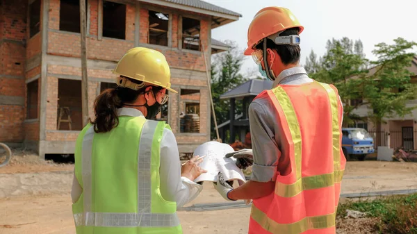 Engineer contractor team meeting work safety plan industry project and check design at the construction building site.