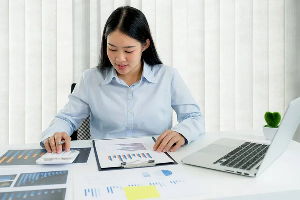 Businesswoman analysis the chart and meeting Video Conferencing with laptop at the home office for setting challenging business goals And planning to achieve the new target.