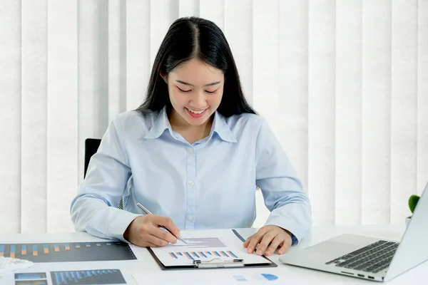 Businesswoman analysis the chart and meeting Video Conferencing with laptop at the home office for setting challenging business goals And planning to achieve the new target.