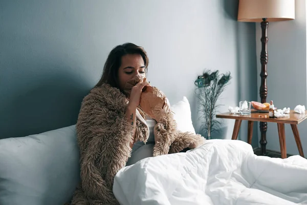 A sick young woman in bed in quarantine